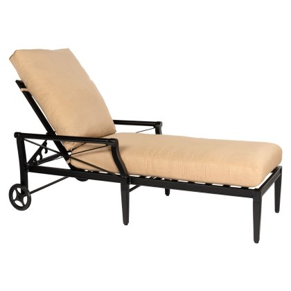 The Andover Adjustable Chaise Lounge features a black metal frame, beige waterfall cushions, two rear wheels, and a backrest that adjusts for reclining positions.
