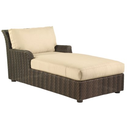 The Aruba Chaise Lounge features a minimalist, elegant design with a dark wicker frame and light beige cushions. It offers a backrest and one-sided armrest, ideal for outdoor use.