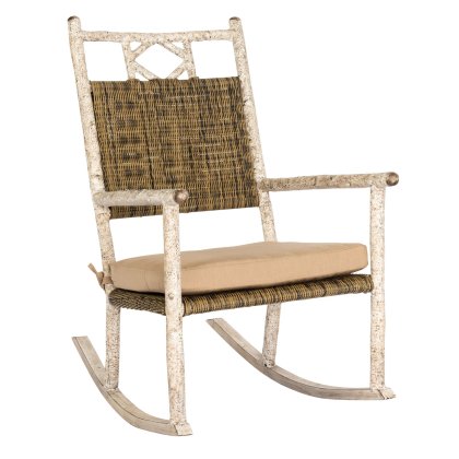 The River Run Small Rocker features a rustic design with a woven backrest, a beige seat cushion for comfort, and white distressed frame with armrests and curved rockers.