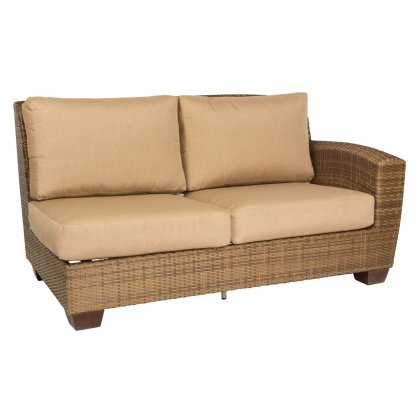 The Saddleback Right Arm Facing Love Seat Sectional features a wicker frame with beige cushions, including two seat and two back cushions, supported by a sturdy woven structure on four small square legs.
