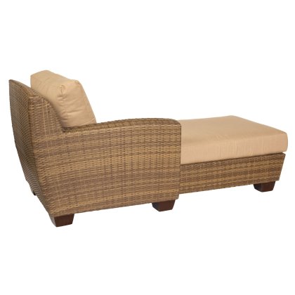 The Saddleback Left Arm Facing Chaise Lounge Sectional features a wicker design with tan cushions, dark wooden legs, woven texture, and high backrest on one side for a relaxing look.