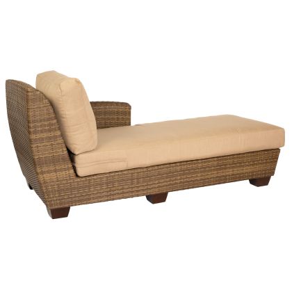 The Saddleback Right Arm Facing Chaise Lounge Sectional features a wicker design with a beige cushion and pillow. It has an armrest on one side and wooden legs, providing stylish and comfortable seating.