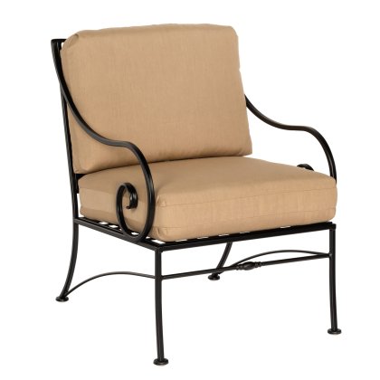 The Sheffield Lounge Chair is a black metal patio chair with beige cushions, featuring curved armrests and a slightly reclined backrest. Its simple yet elegant frame is perfect for outdoor settings.