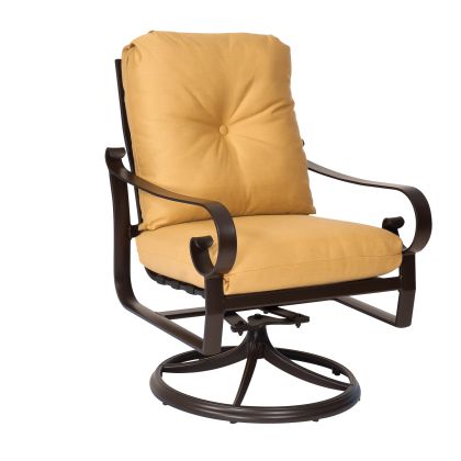 The Belden Cushion Swivel Rocking Dining Armchair is a brown metal swivel chair with armrests and a circular base, featuring yellow button-tufted cushions for added design detail.