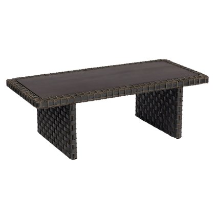 The Cooper Rectangular Coffee Table is a dark brown, rectangular, woven wicker piece with a smooth top and two sturdy legs forming a checkered-patterned base.
