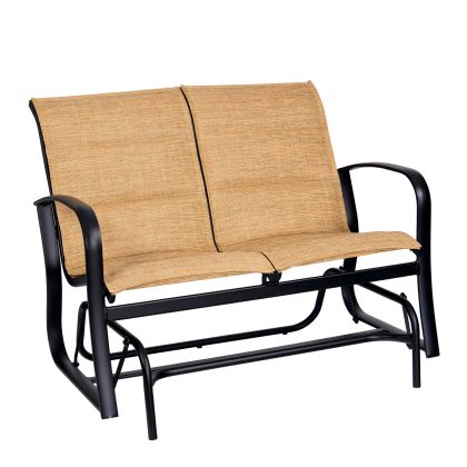 The Fremont Padded Sling Gliding Love Seat is a two-seater outdoor bench with beige fabric seats, a black metal frame, curved armrests, and a sturdy base designed for smooth rocking motion.