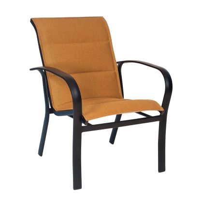 The Fremont Padded Sling Dining Armchair features orange fabric seating, a sleek black metal frame with curved armrests, and a slightly reclined backrest, making it ideal for patio or garden use. It is also stackable.