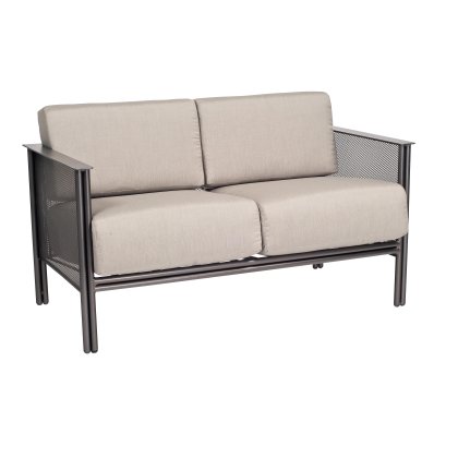 The Jax Love Seat features a black metal frame with modern mesh design arms and back, complemented by light beige cushions. Set against a white background, its contemporary style stands out.