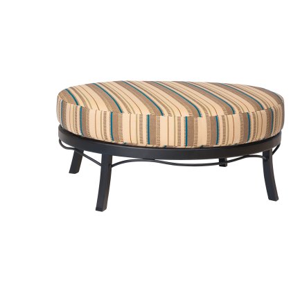 The Aluminum Occasional Ottoman features a round striped cushion in beige, brown, blue, and black, supported by a black metal frame with curved details and four legs.