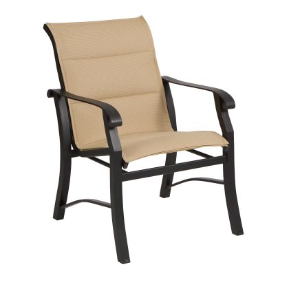 The Cortland Padded Sling Dining Armchair is a beige outdoor chair with a black metal frame and armrests, perfect for your patio or garden.