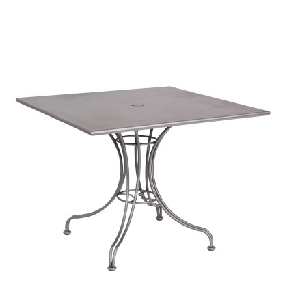 The Solid Iron Top Universal Square Dining Umbrella Table is a sleek, square metal table with a minimalist design, flat top, and elegant curved legs. It includes a central hole for an umbrella, making it perfect for both indoor and outdoor use.