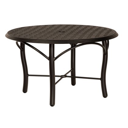 The Thatch Tribeca Round Umbrella Coffee Table is a round black metal table featuring a woven design on top, curved legs, and a simple, modern style.