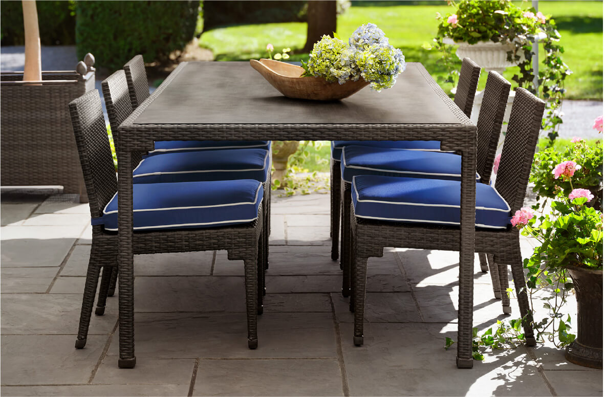 The Lorenzo 7 piece outdoor woven dining set with blue cushions